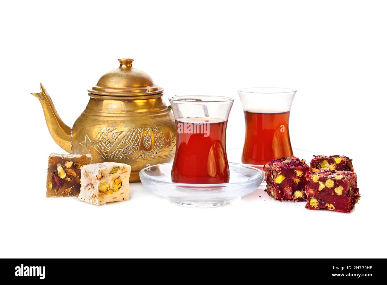 Traditional turkish delight rahat lokum with two glasses of tea and