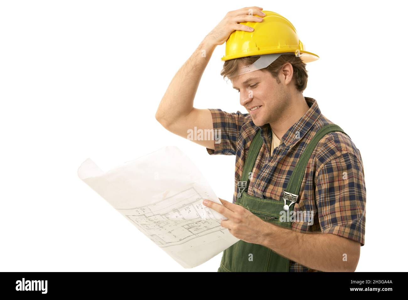 Young builder looking at floor plan Stock Photo