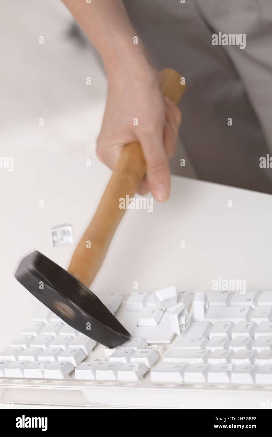 Smashing keyboard with hammer Stock Photo Alamy