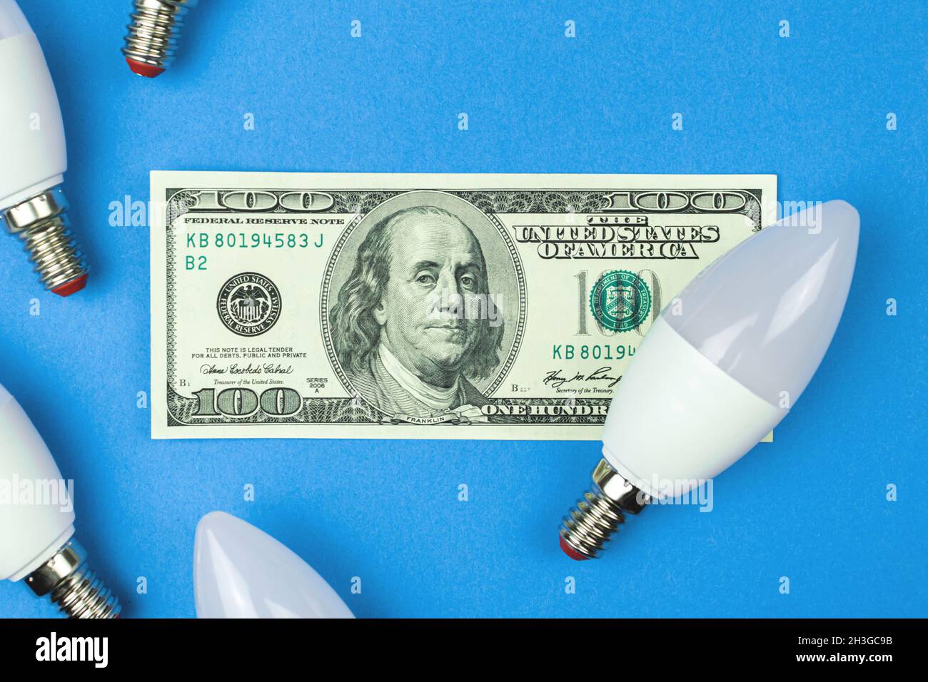 Electricity costs. LED light bulbs and money, dollar bills. Energy