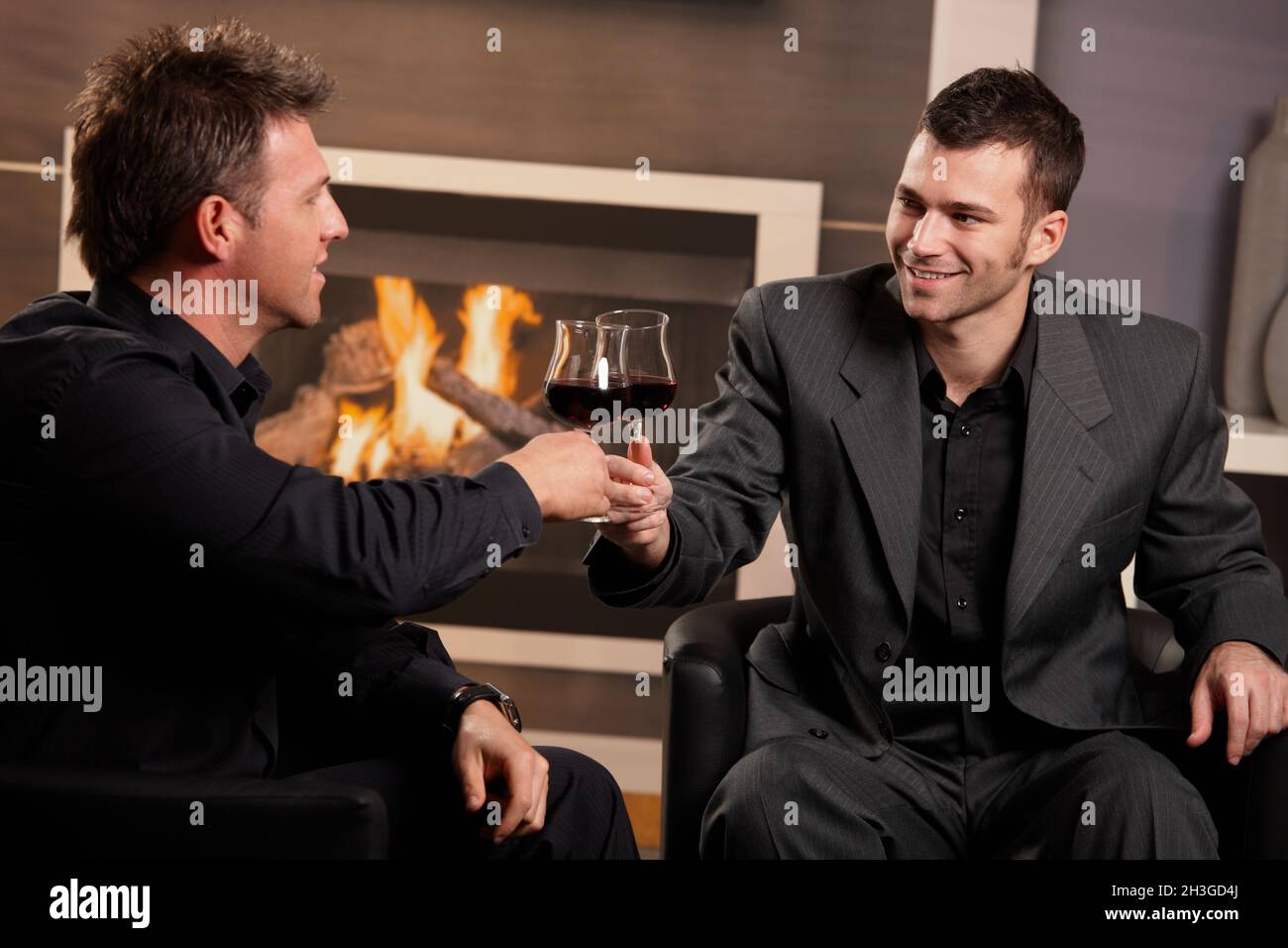 Businessmen clinking glasses hi-res stock photography and images - Alamy