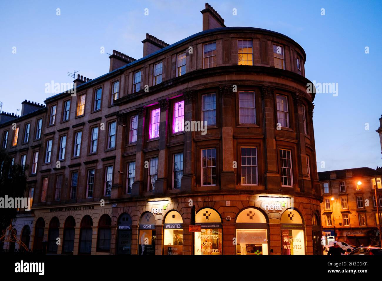 Finnieston, Glasgow tenements at night. Neon lights and shop front. Blue light, golden hour. City centre Stock Photo