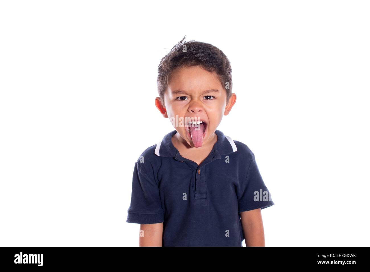 Boy sticking out his tongue isolated on white background. Boy making rock and roll gesture with tongue. Stock Photo