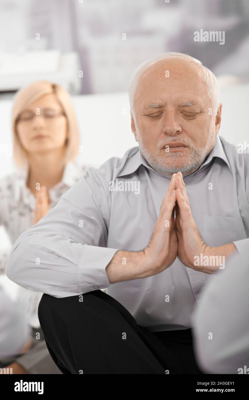 Portrait of meditating businessman Stock Photo - Alamy