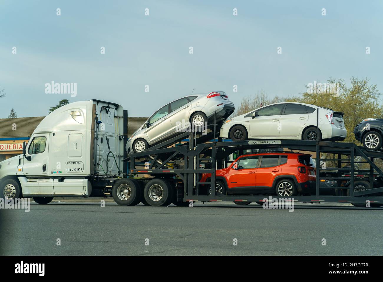 SACRAMENTO, UNITED STATES - Mar 17, 2021: The cars being transported by a car hauler during the daytime Stock Photo