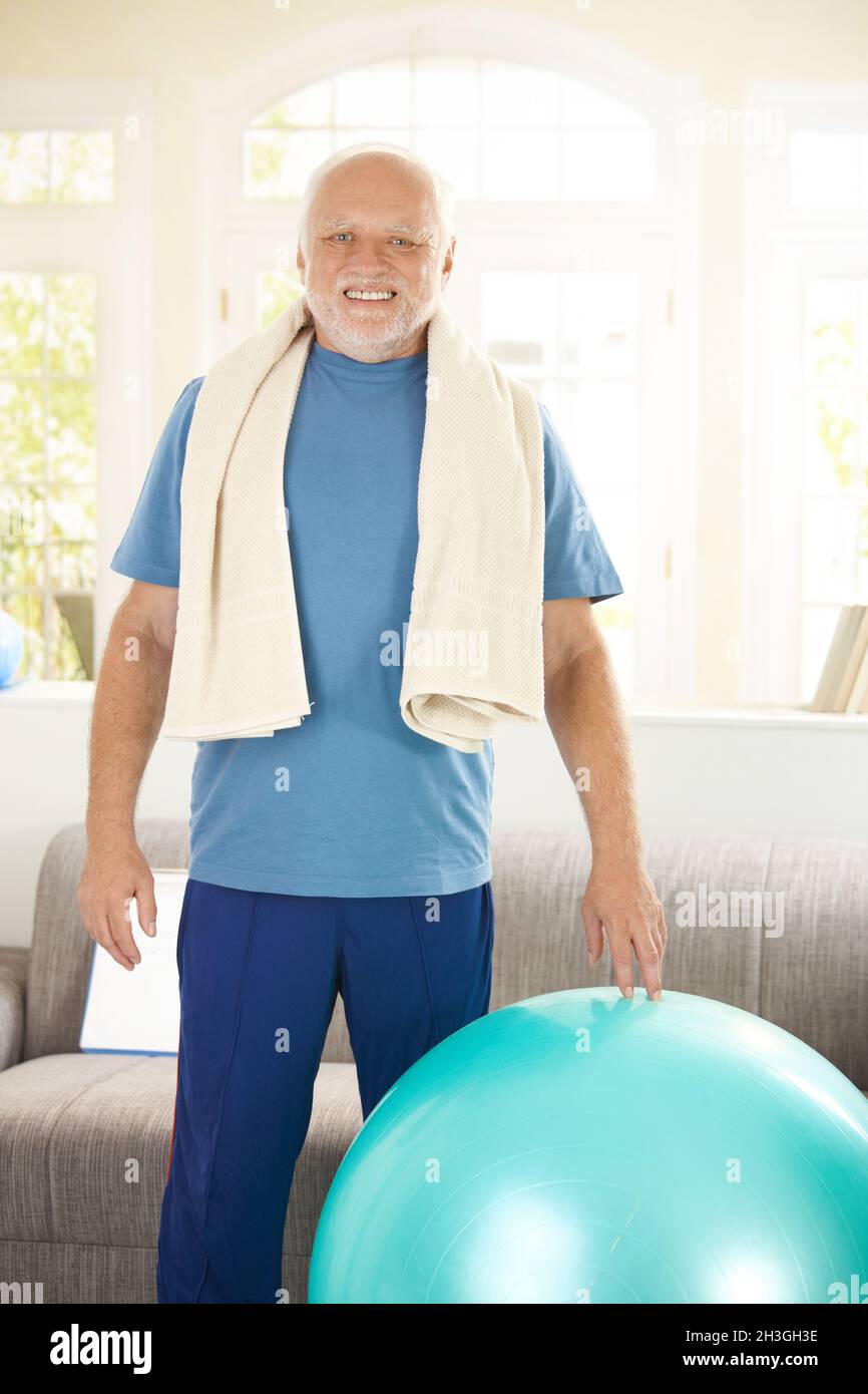 Active senior exercising with fit ball Stock Photo