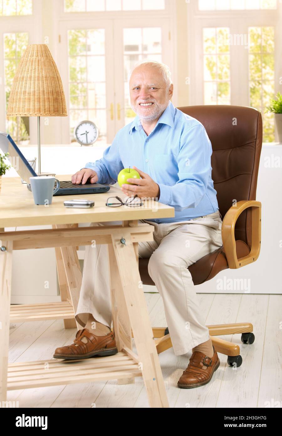 Older man working in his study Stock Photo