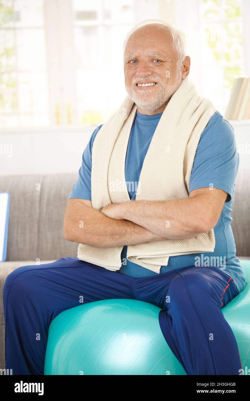 Active senior sitting on fit ball Stock Photo