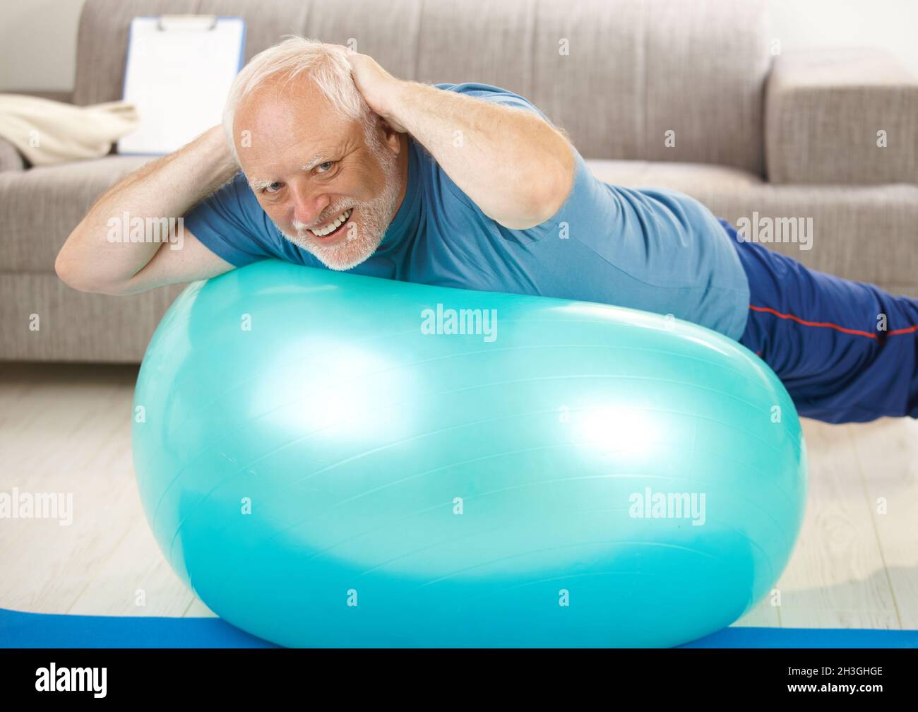 Active senior doing exercises on gym ball Stock Photo