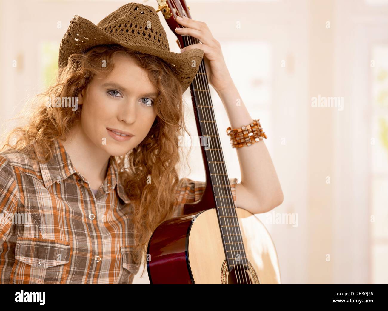 Attractive girl resting on guitar Stock Photo - Alamy
