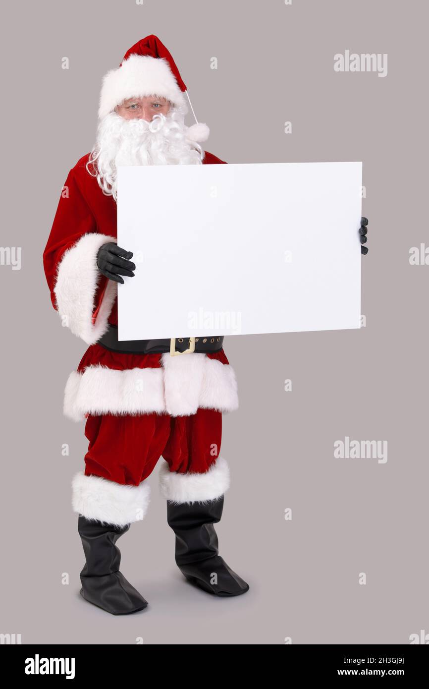Santa holding blank white board Stock Photo - Alamy