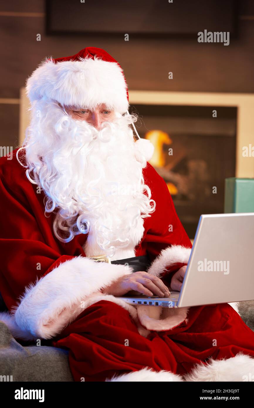 Santa using computer Stock Photo - Alamy