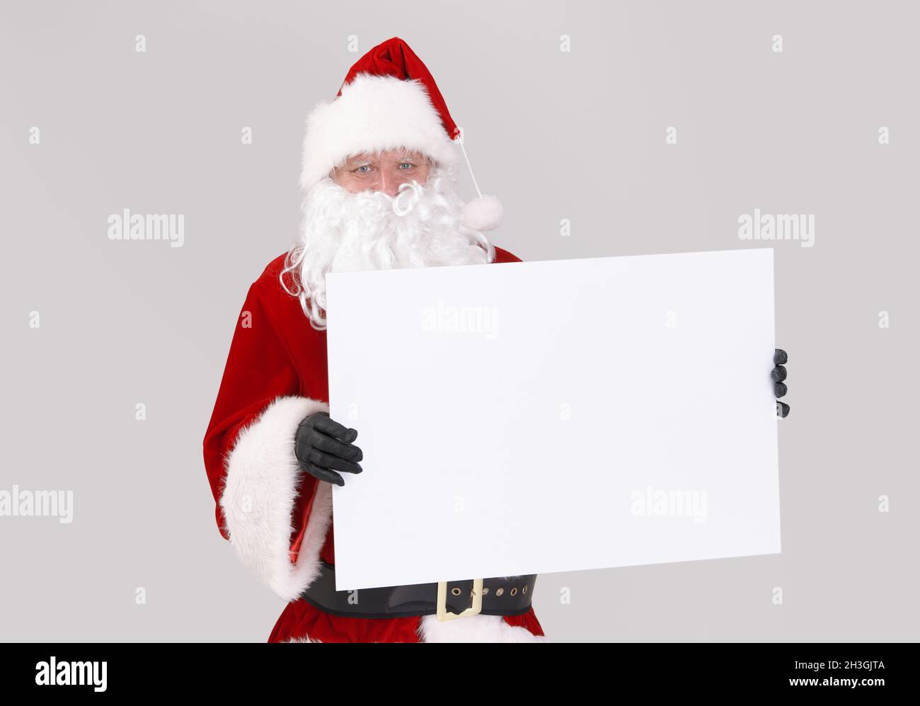 Santa holding blank white board Stock Photo - Alamy