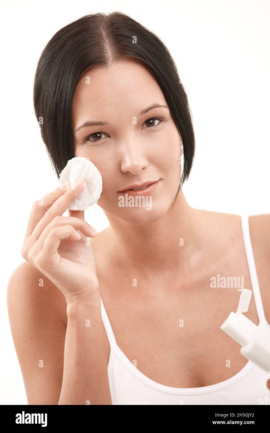 Beautiful young woman cleaning face Stock Photo