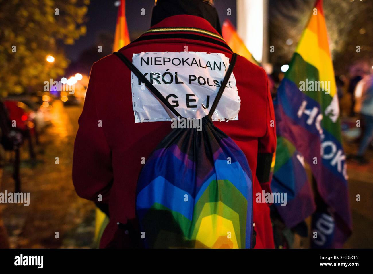 A protester wears a placard on his back with inscriptions during the demonstration.People gathered outside the Polish Parliament in Warsaw to protest against a law proposal that would put a total ban on equality marches. If the so called “Stop LGBT” bill is passed, prides and equality marches will be banned, as well as any other public gatherings that “promote” non-heterosexual orientations and heterosexual gender identities. Today in the Parliament's lower house a discussion was held on this project, and a vote is scheduled for 29th of October. 'Stop LGBT' is a civic bill for which signatures Stock Photo