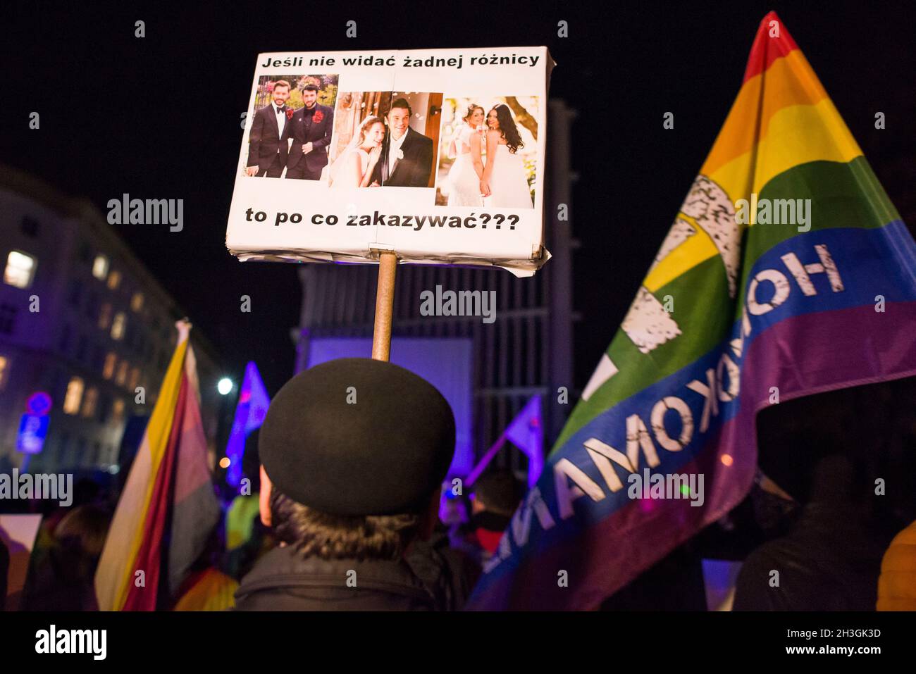 Protesters hold placards and rainbow flags expressing their opinion during the demonstration.People gathered outside the Polish Parliament in Warsaw to protest against a law proposal that would put a total ban on equality marches. If the so called “Stop LGBT” bill is passed, prides and equality marches will be banned, as well as any other public gatherings that “promote” non-heterosexual orientations and heterosexual gender identities. Today in the Parliament's lower house a discussion was held on this project, and a vote is scheduled for 29th of October. 'Stop LGBT' is a civic bill for which Stock Photo