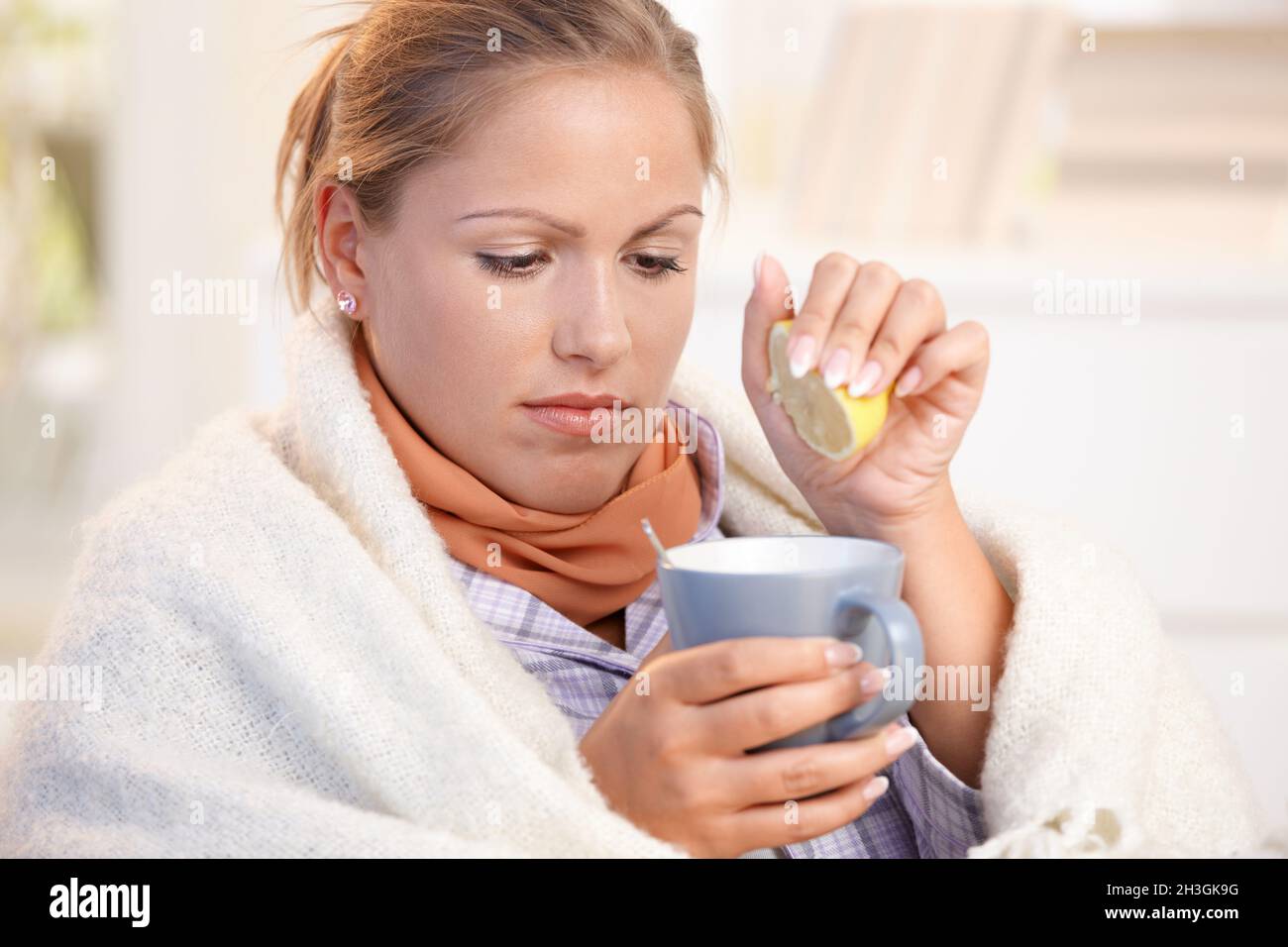 Young female caught cold drinking tea feeling bad Stock Photo