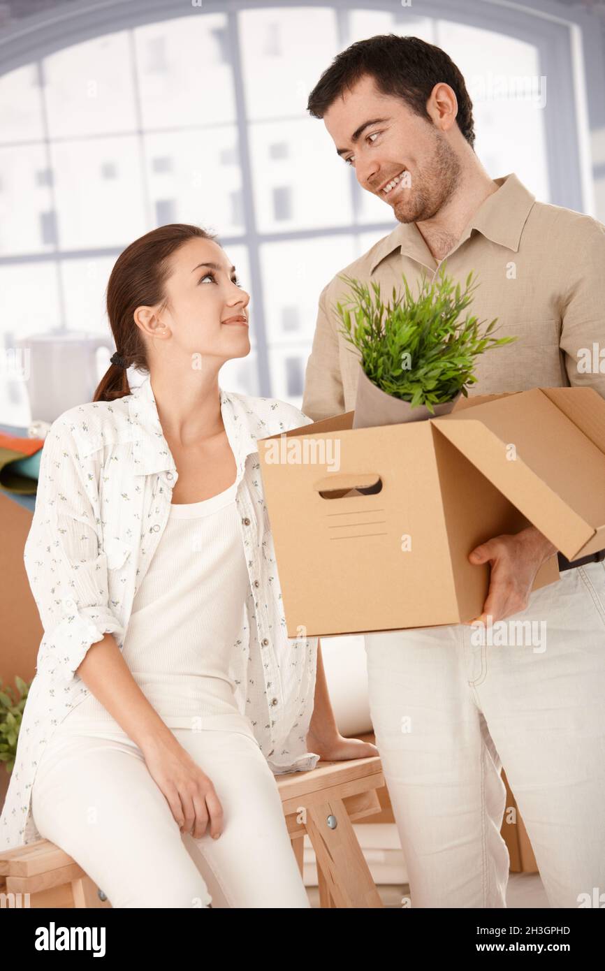 Happy couple unpacking boxes in new home Stock Photo