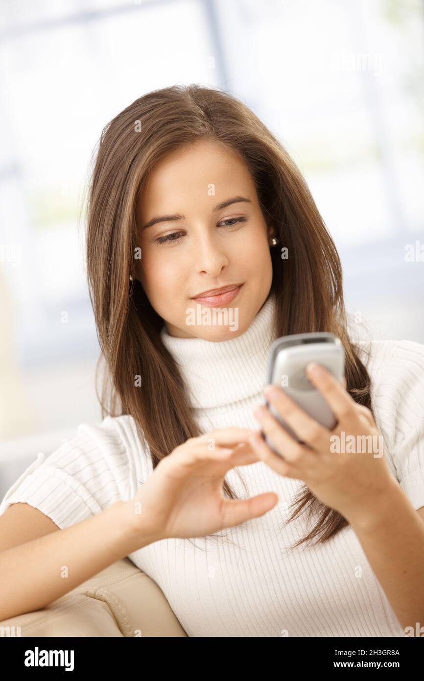 Text While Smiling Smiling casual woman texting message hi-res stock photography and ...