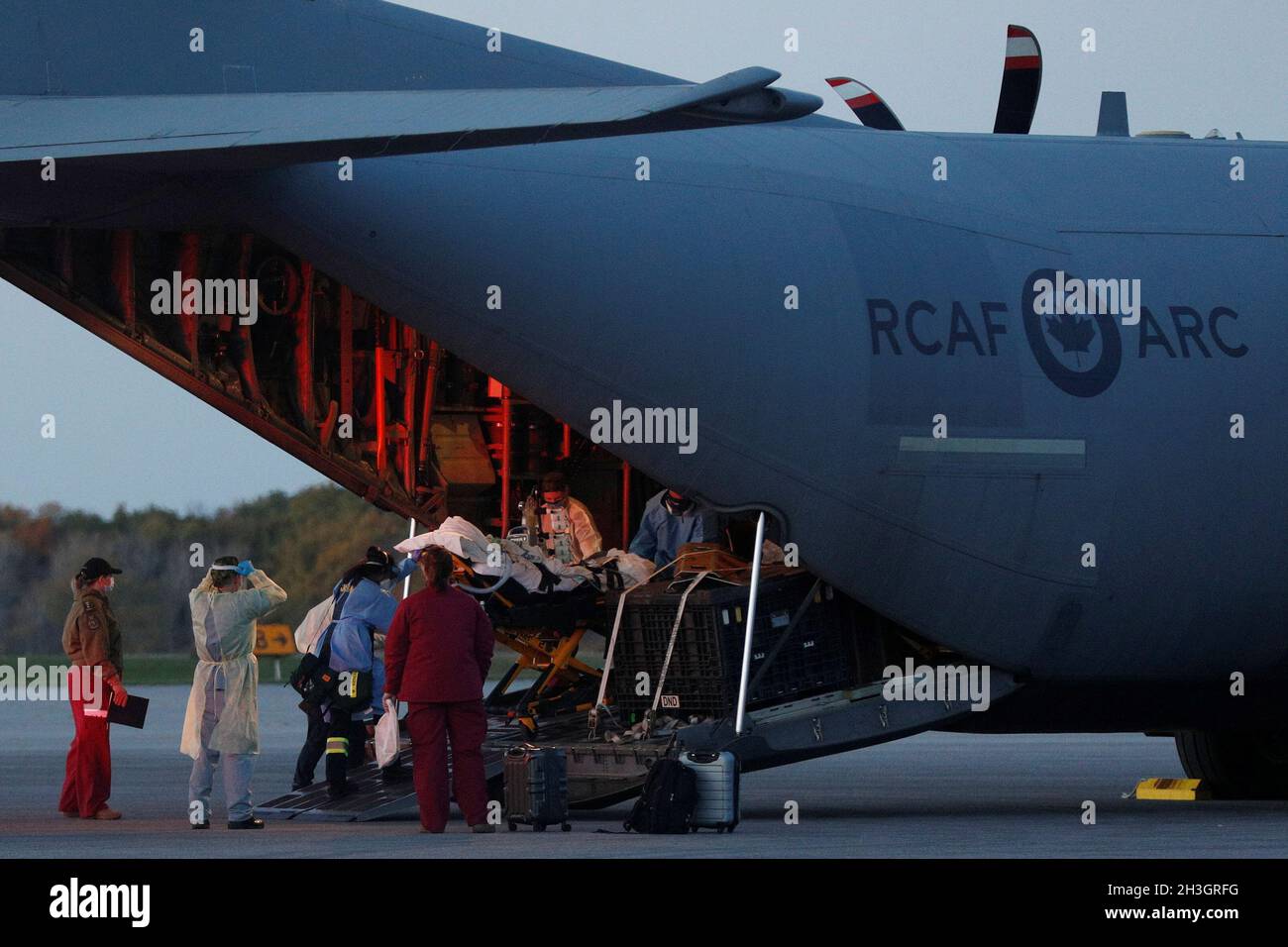 Medical personnel unload a patient from a Royal Canadian Air Force CC-130J  Hercules transport aircraft which departed from Saskatoon, after the  province of Saskatchewan said it would be sending coronavirus disease  (COVID-19)