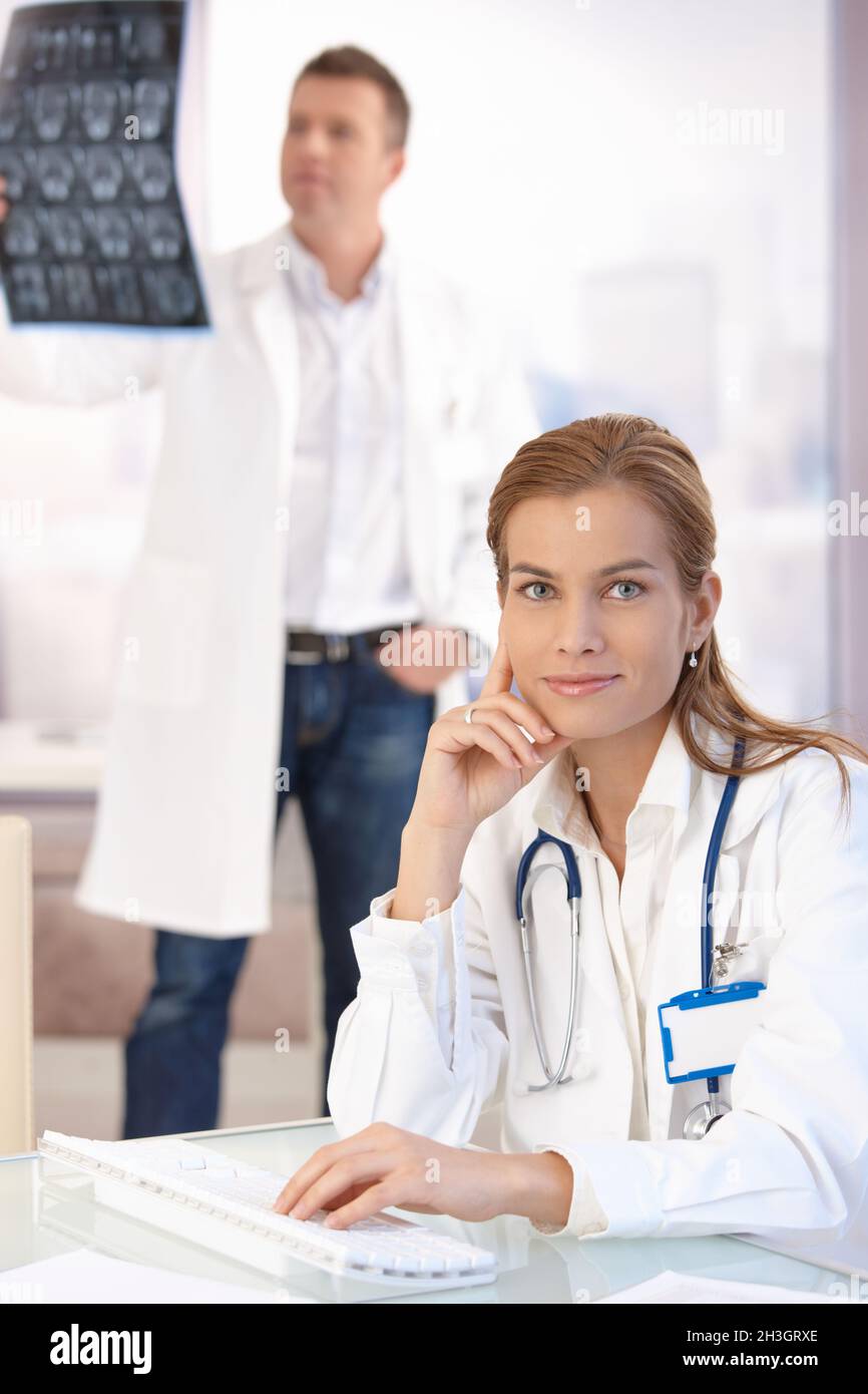 Attractive female doctor working on computer Stock Photo
