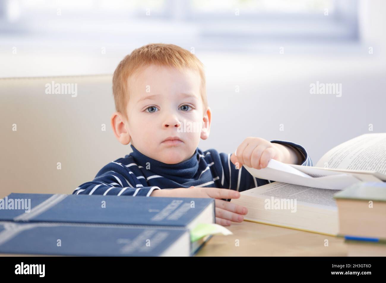 Little scholar with encyclopedia Stock Photo