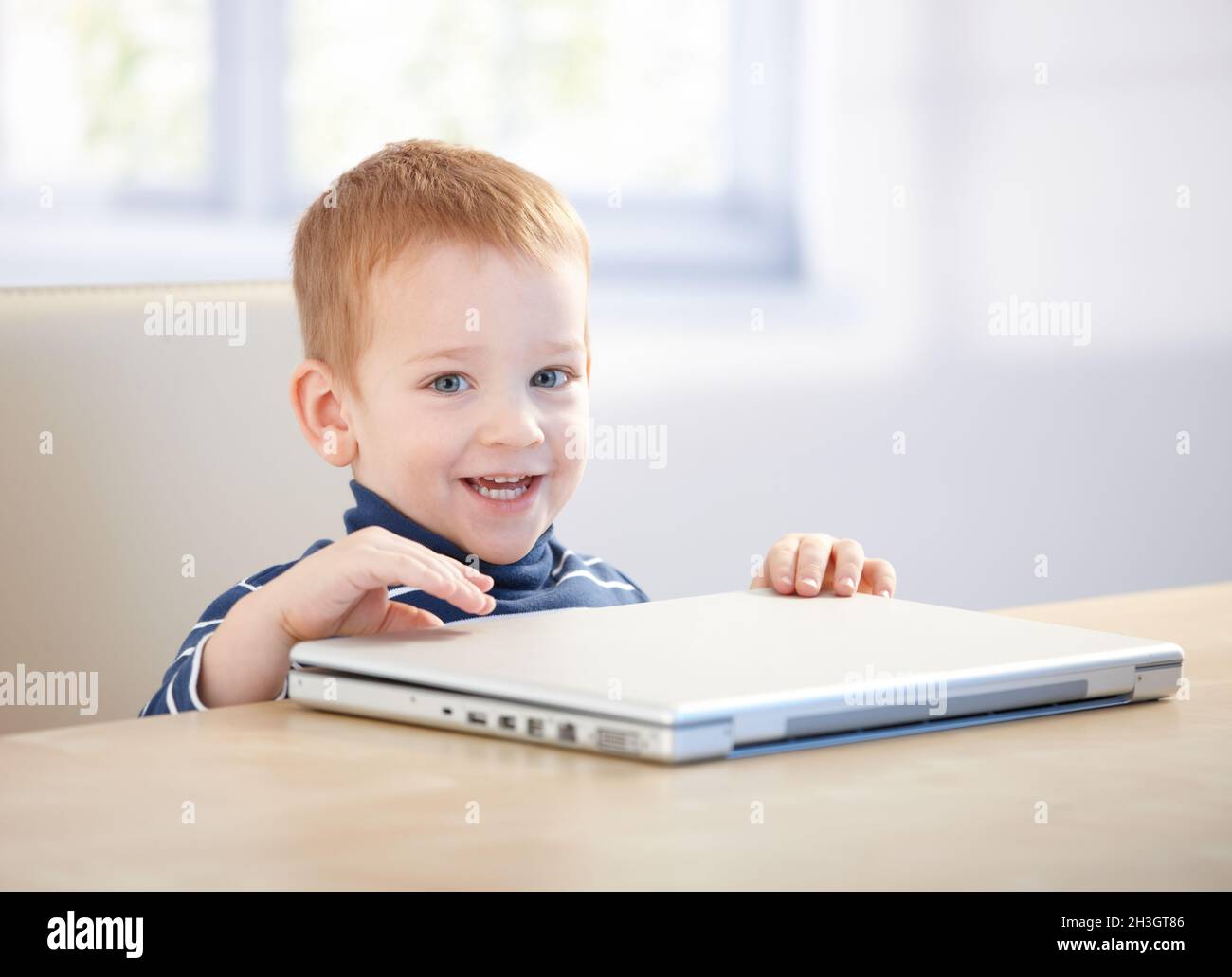 Adorable little boy smiling with laptop Stock Photo - Alamy