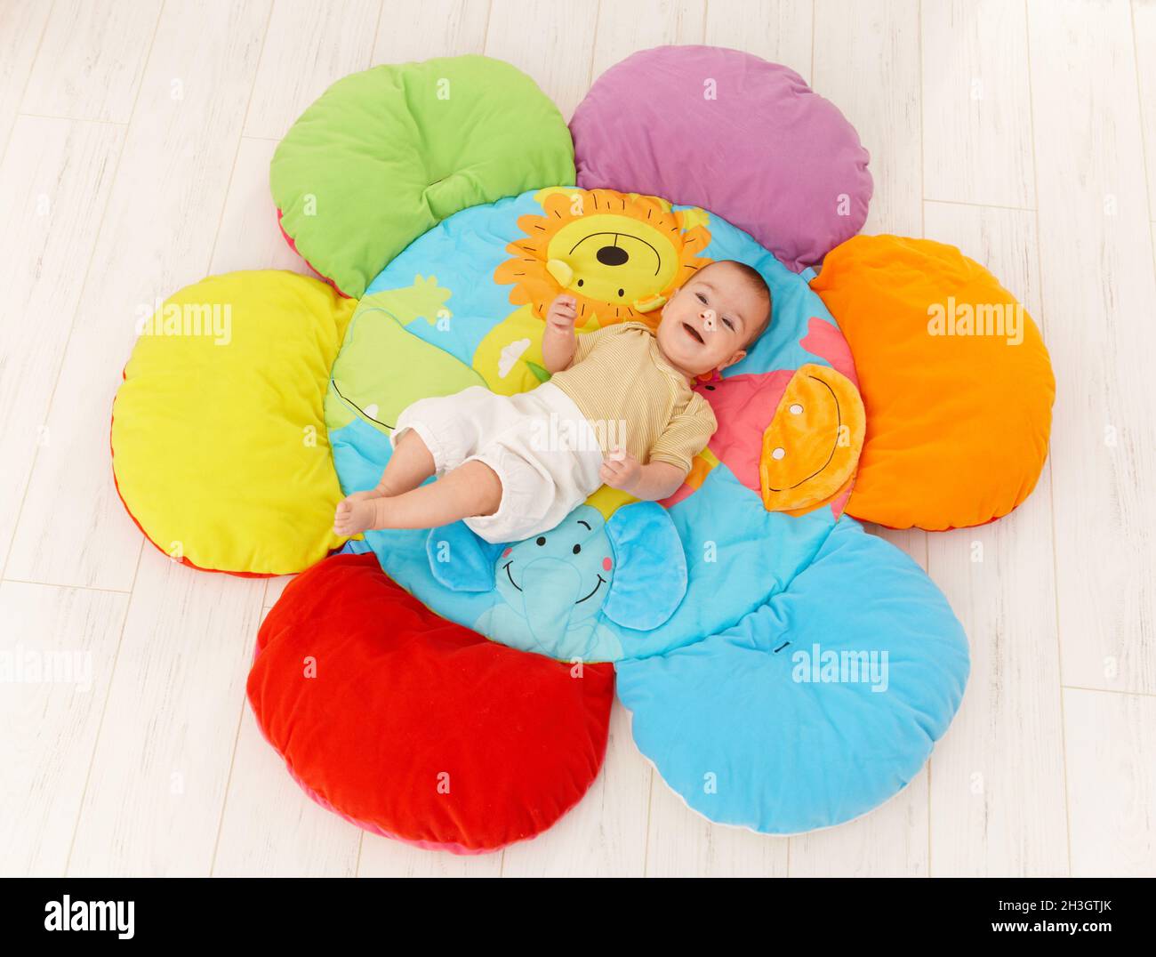 Happy baby on playmat Stock Photo Alamy