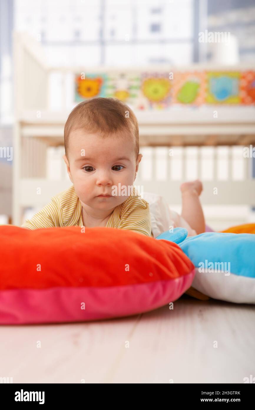 Sleepy baby on playmat Stock Photo Alamy
