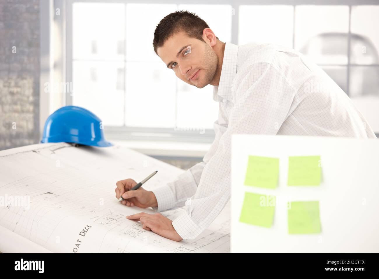 Handsome engineer drawing plans Stock Photo
