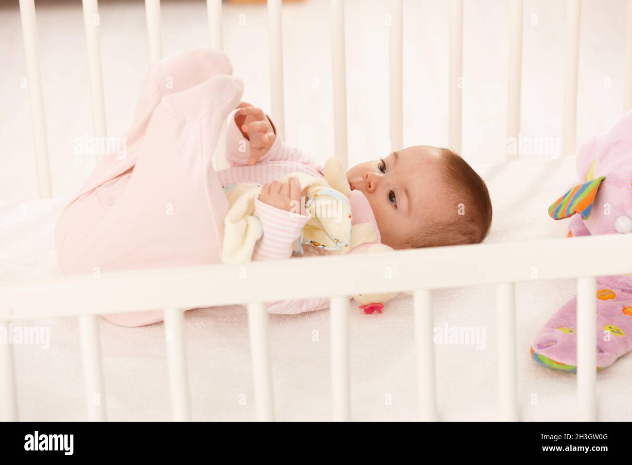 Cute baby playing with feet Stock Photo - Alamy