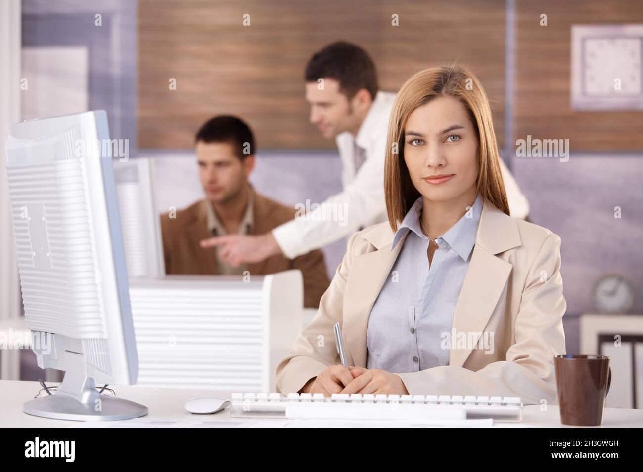 Pretty businesswoman at training course smiling Stock Photo