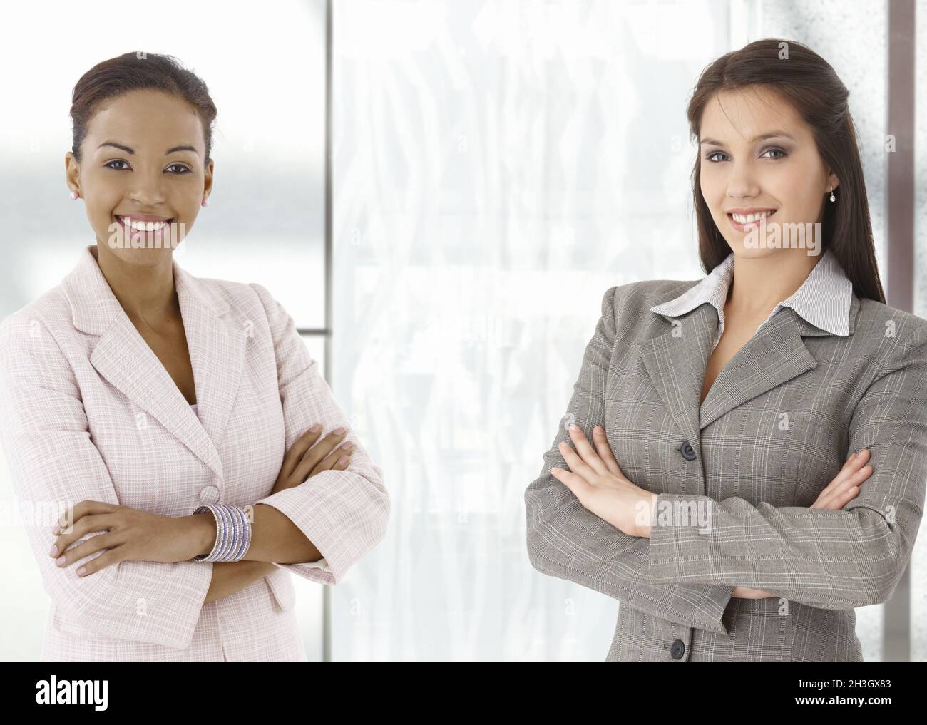 Portrait of happy young businesswomen in office Stock Photo
