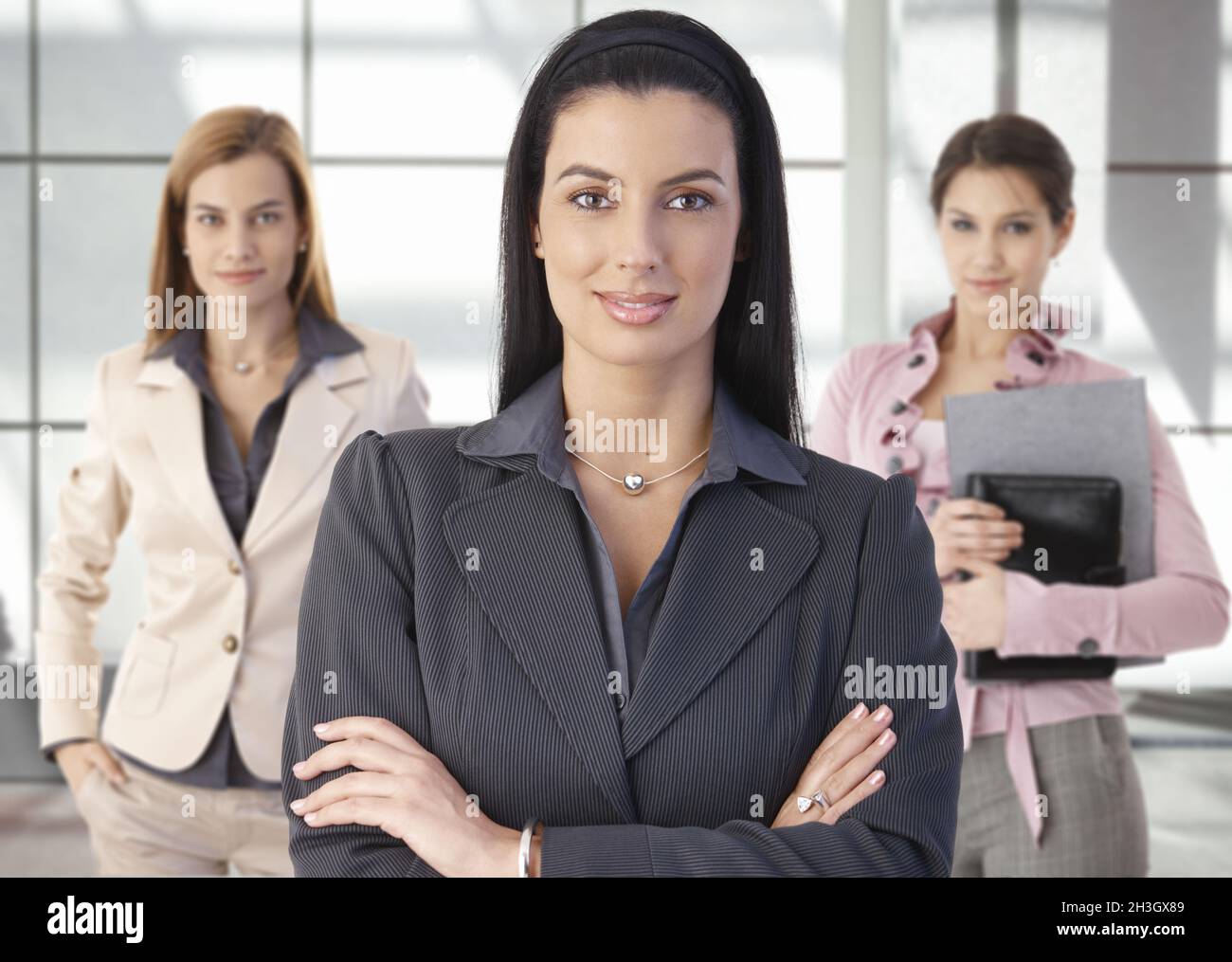 Team portrait of happy businesswomen in office Stock Photo