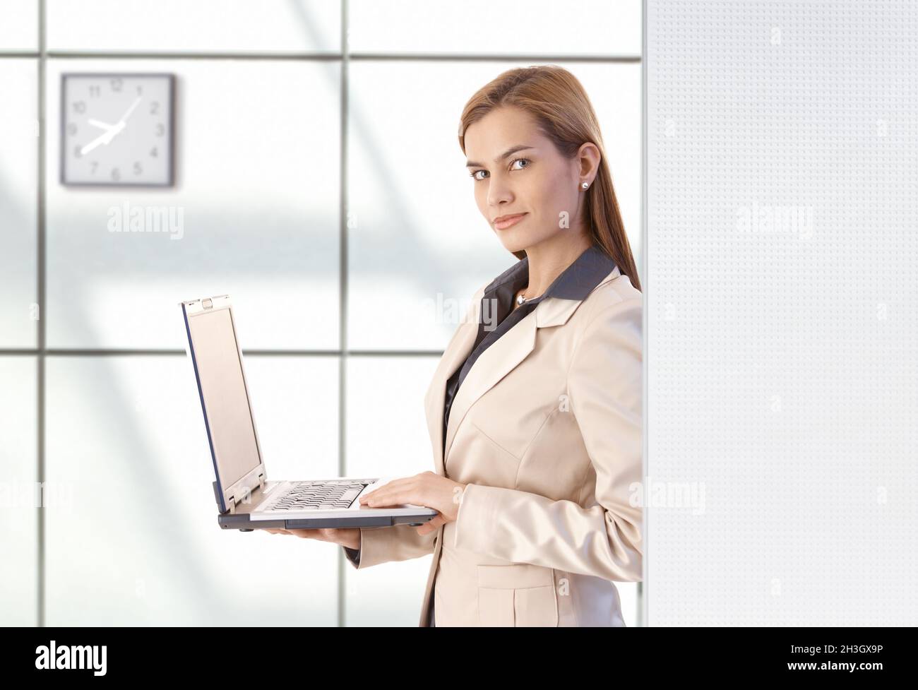 Attractive businesswoman using laptop smiling Stock Photo