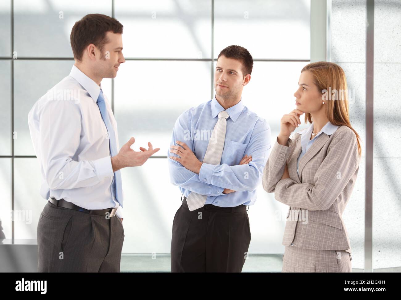 Casual office workers talking in hallway Stock Photo