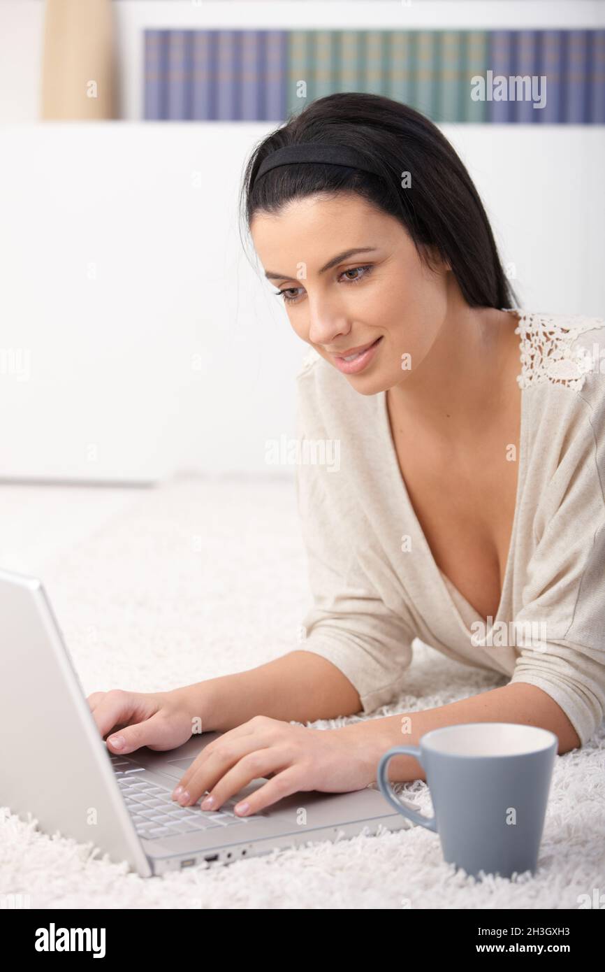 Woman using computer at home Stock Photo