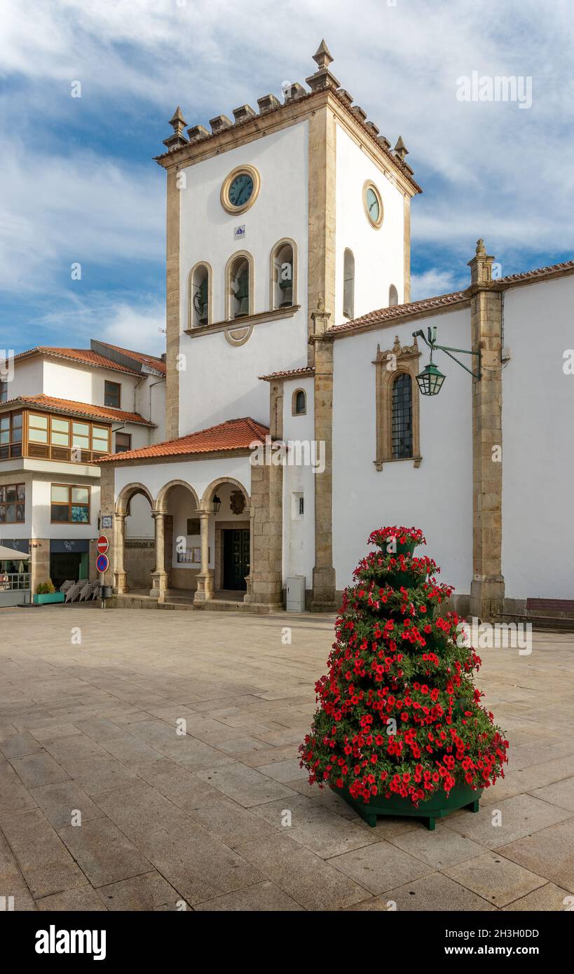 Bragança, Portugal - June 26, 2021: Bragança Cathedral Tower in Portugal, seen from the square with floral arrangement in the foreground. Stock Photo