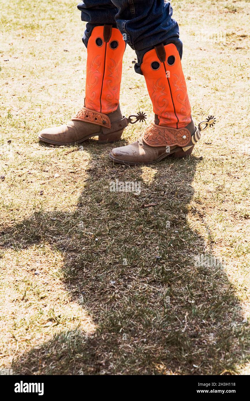 Cowboy with orange cowboy boots, Alberta Canada. Stock Photo