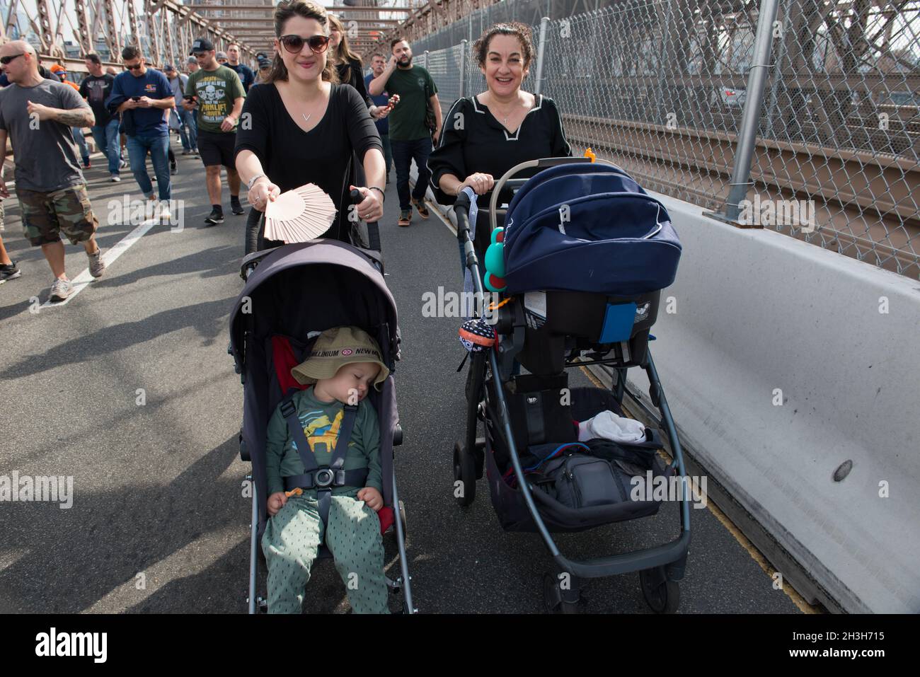 New York City, USA, 25 October 2021, Anti vaccine mandate protestor Moms with their babies in tow, crossing the Brooklyn Bridge. Stock Photo