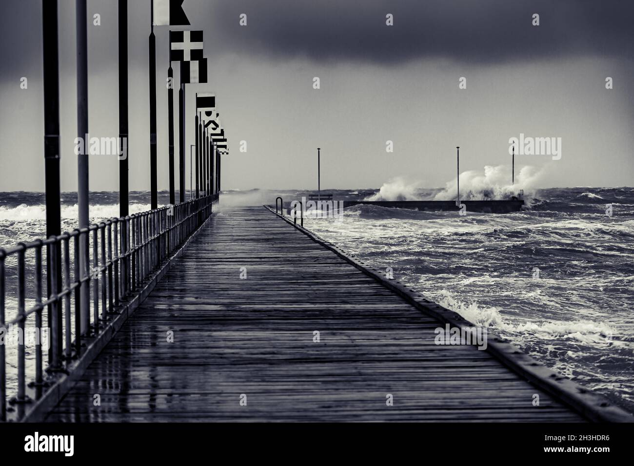 Moody Frankston Pier as Windy Storm Batters with Crashing Waves Stock Photo