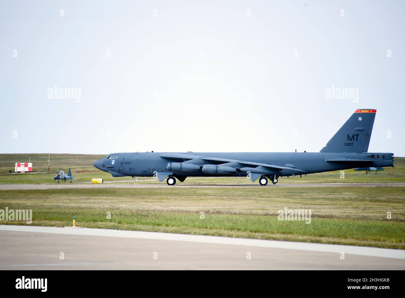 A B-52 Stratofortress from Minot Air Force Base, North Dakota, pauses during it's taxi down the runway as a T-38 Talon II exits the area, at Sheppard AFB, Texas, Oct. 21, 2021. The B-52 visited Sheppard AFB to give undergraduate pilot training and aircraft maintenance technical training students were able get an up-close look at an operational version of the aircraft. The flight crew of the Stratofortress provided capability briefings to the UPT students, and enlisted crew talked to technical training students about the aircraft. (U.S. Air Force photo by Staff Sgt. Robert L. McIlrath) Stock Photo