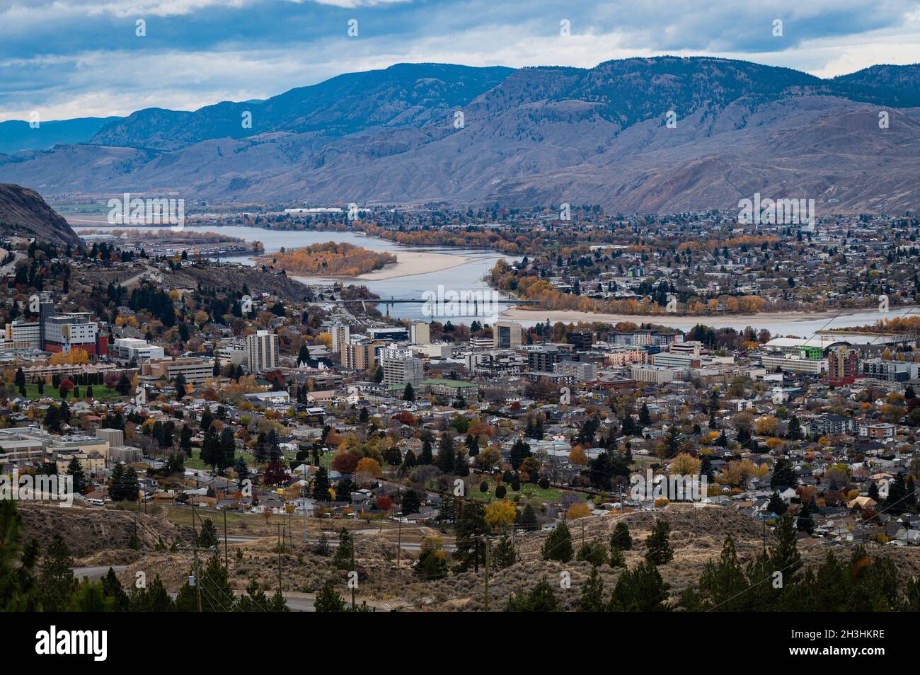 View looking west from the Rose Hill area of the South Thompson River, hills, Mt Peter and Paul, bridges, and the city of Kamloops. Stock Photo