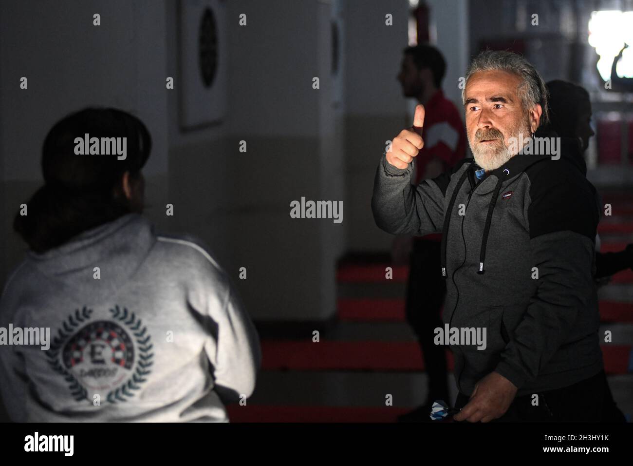 A senior man giving a thumbs up sign Stock Photo