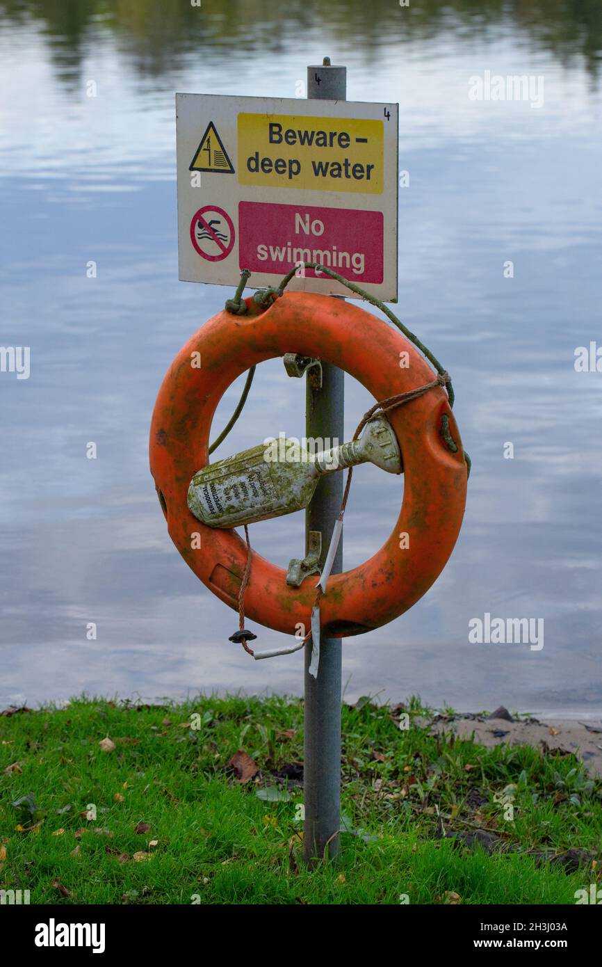 Health and Safety sign. Witlingham Park, Norwich. Beware-deep water. No Swimming. Alongside unfenced lake with public access. Cautionary warning risk Stock Photo