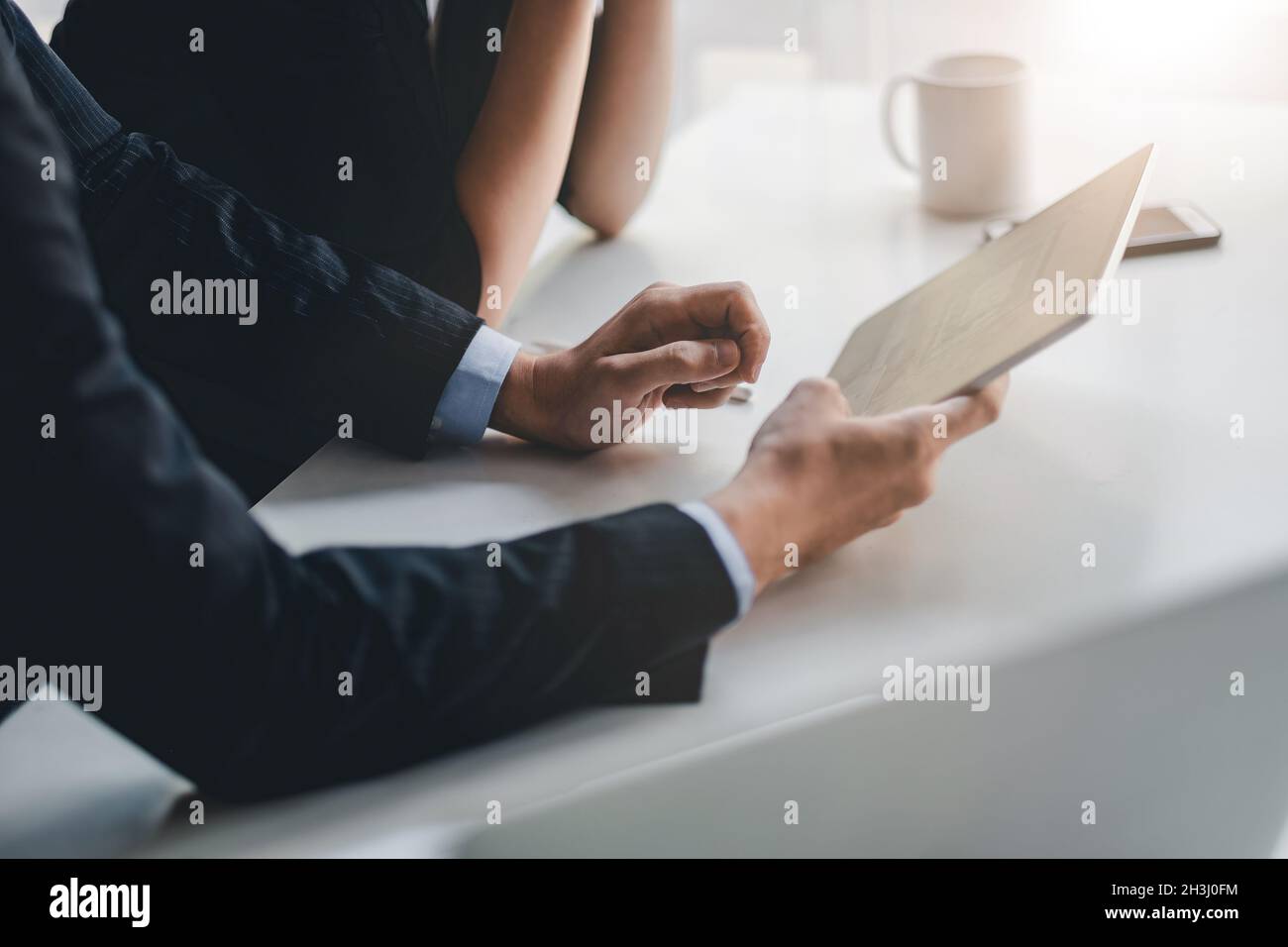 Close up had of business people working together with digital tablet in office meeting room, colleague discussion about project work. Stock Photo