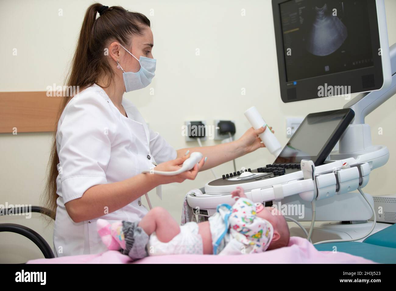 The doctor makes an ultrasound scan for a newborn baby.Medical exam of