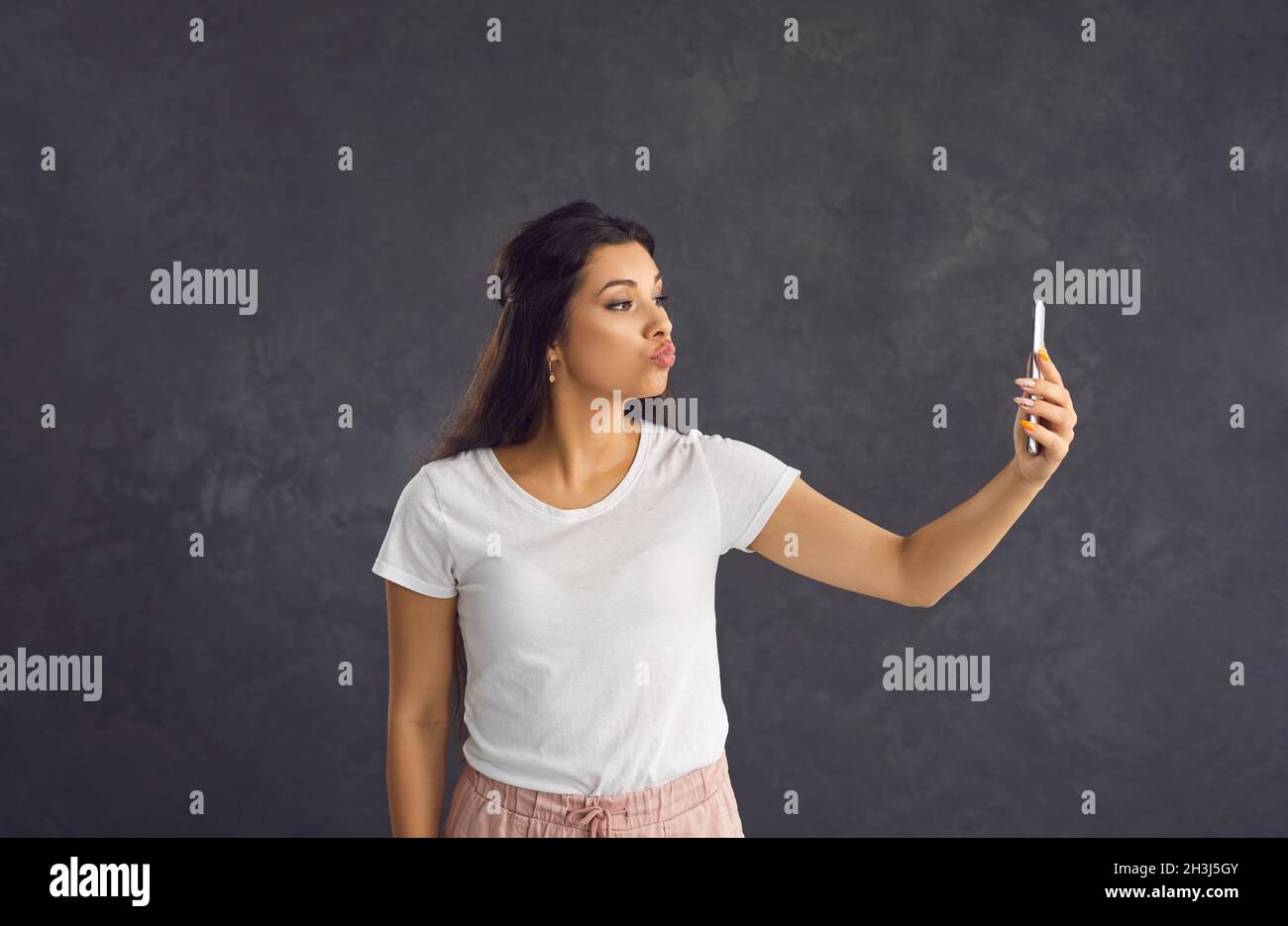 Millennial Hispanic woman speak on video call on cell Stock Photo - Alamy