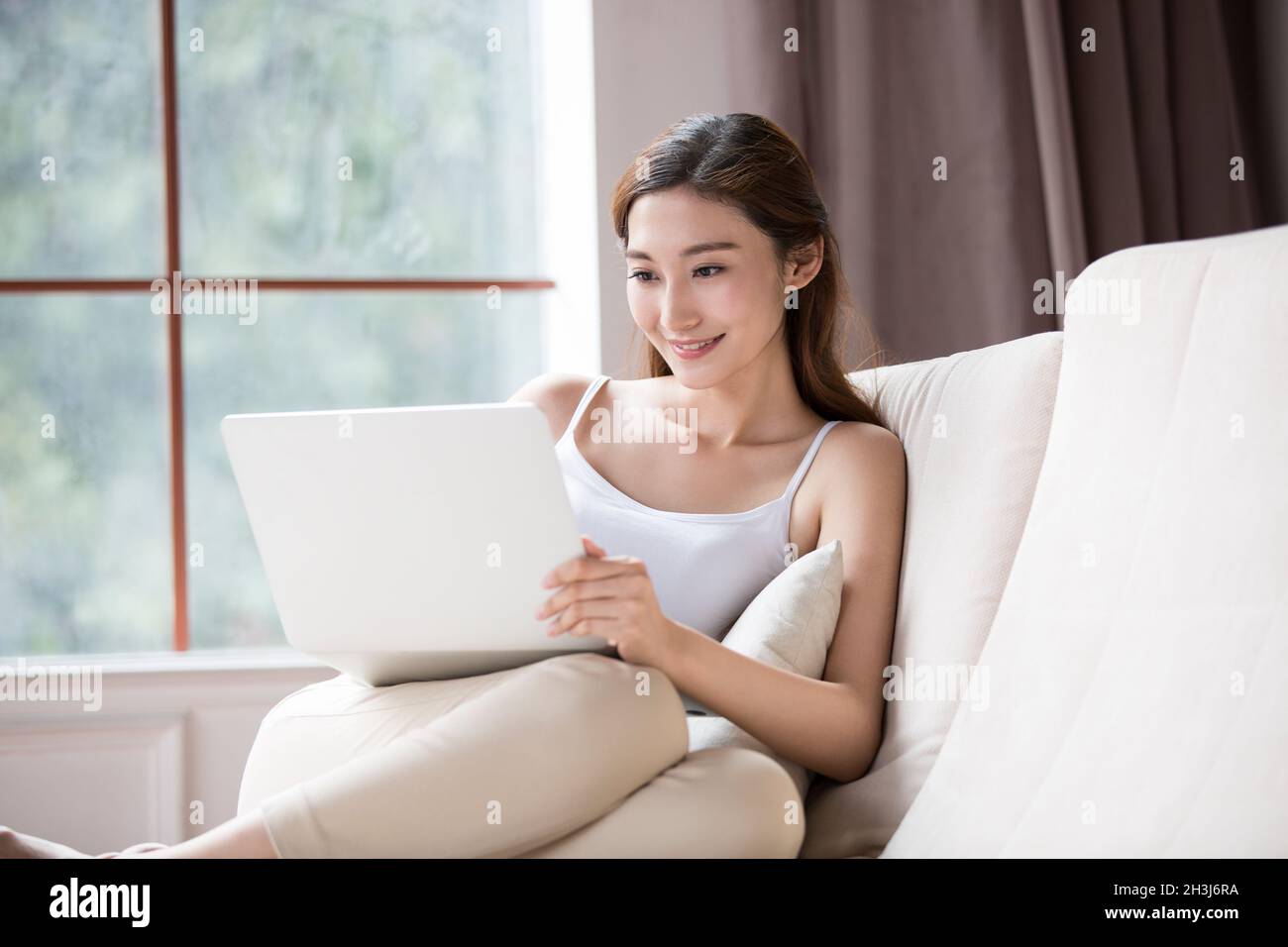 Young woman using a laptop computer Stock Photo