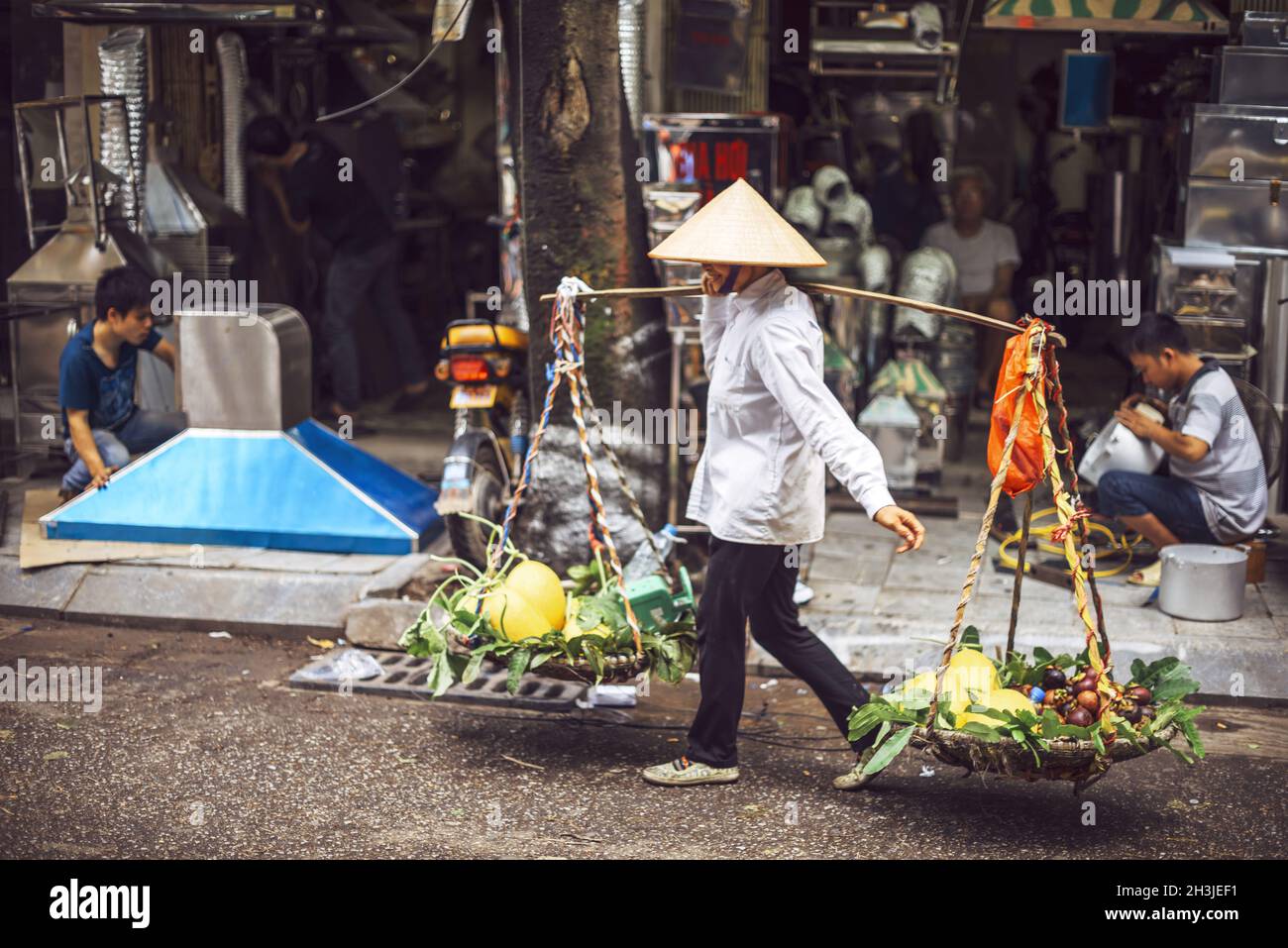 Hanoi, Vietnam - May 2, 2015: Vietnamese street market lady seller, on May 2, 2015, in Hanoi, Vietnam Stock Photo